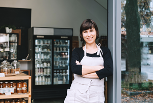 female business owner standing outside shop